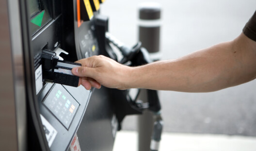 Man inserting his credit card at the gas pump