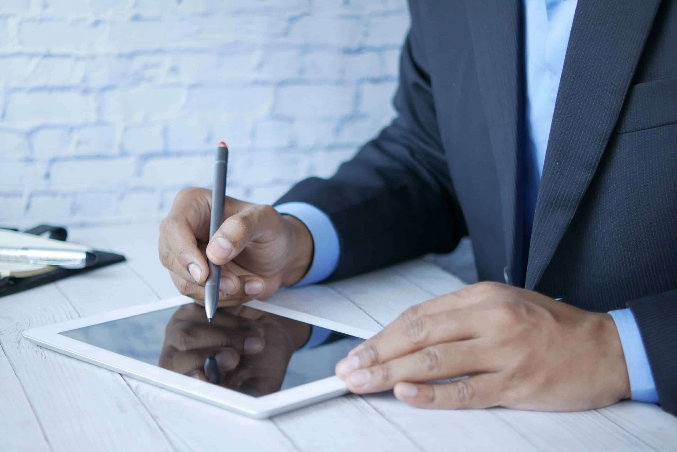 Man in suit working on tablet