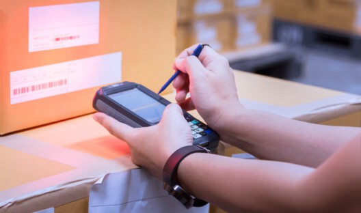person-taking-inventory-on-a-handheld-device