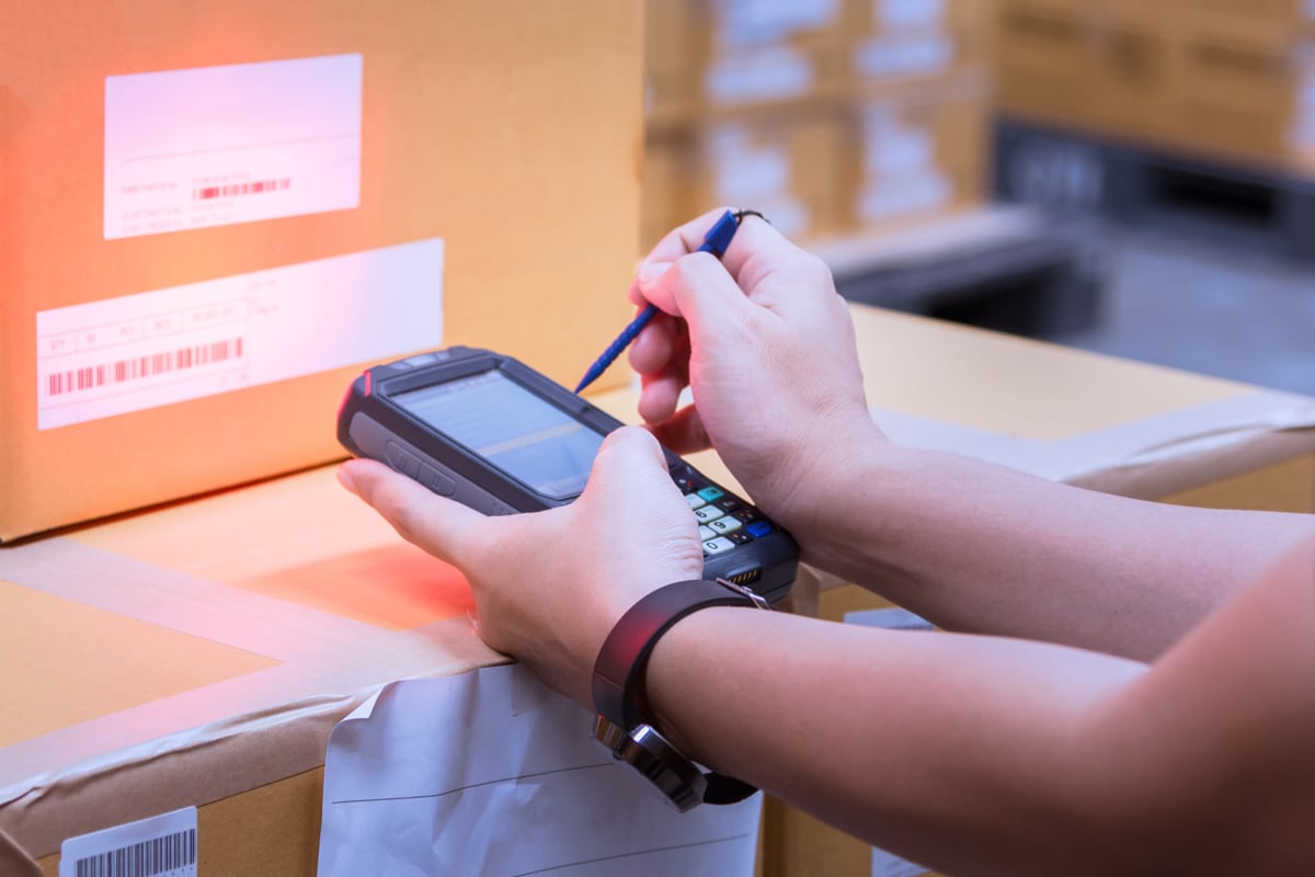 person-taking-inventory-on-a-handheld-device